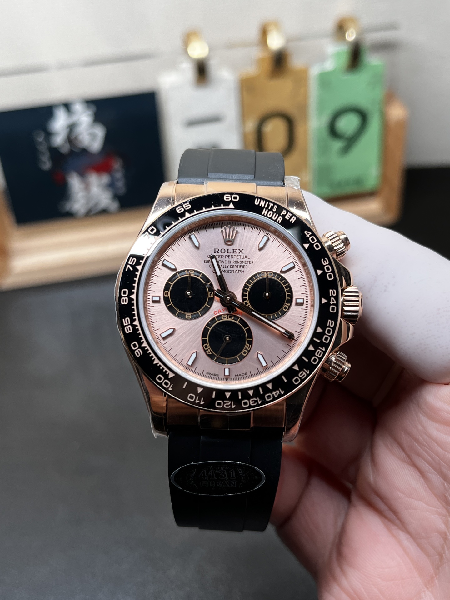 Rose gold Daytona replica Rolex with pink dial and black rubber strap front view