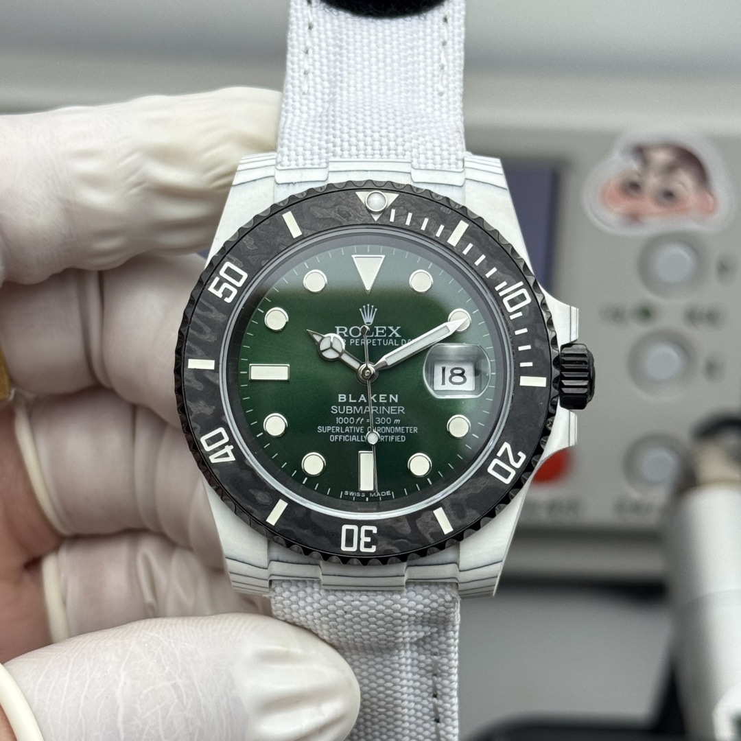 Front view of premium Blaken Submariner replica watch with deep green sunburst dial, luminous markers, date window showing 18, carbon fiber patterned bezel and white fabric NATO strap on high-quality best replica watches