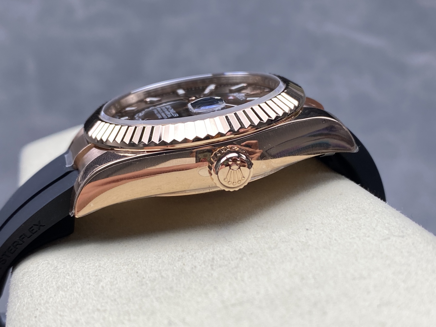 Side profile of a rose gold Rolex Sky-Dweller replica showing fluted bezel crown and case thickness