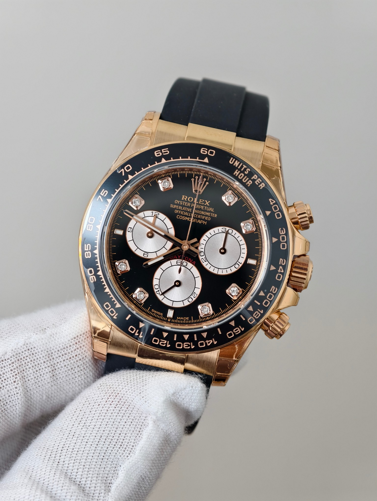 Detailed view of Rolex replica clasp mechanism with gold tone and black strap