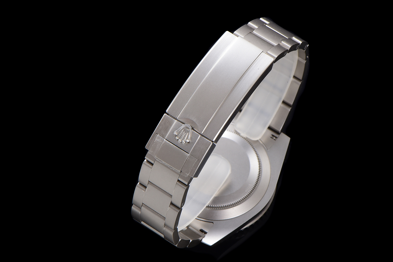 Angled view of Rolex watch bracelet clasp with engraved crown logo and screw-down case back