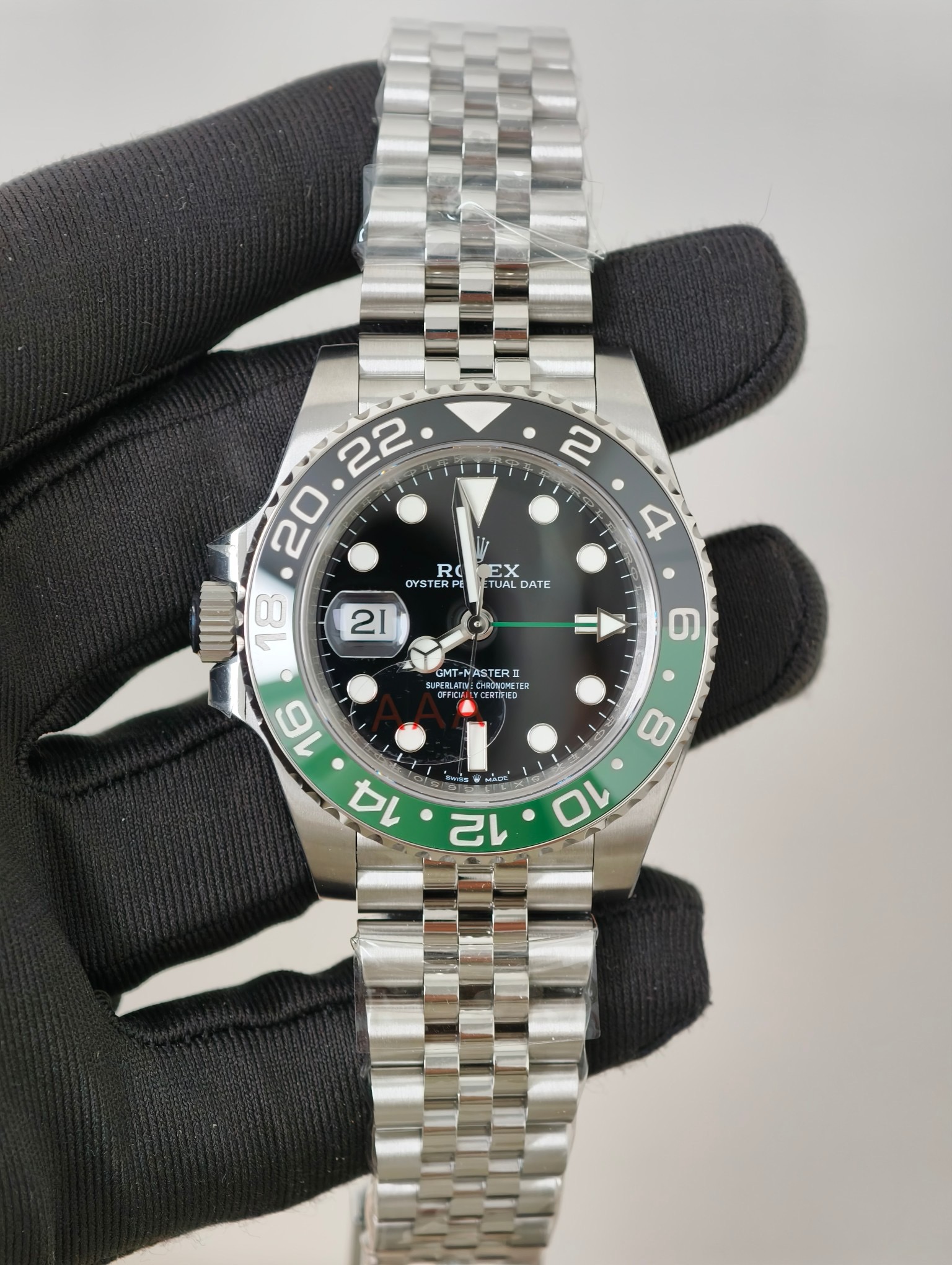 Rolex GMT-Master II replica full front view with black dial, green GMT hand, and Jubilee bracelet