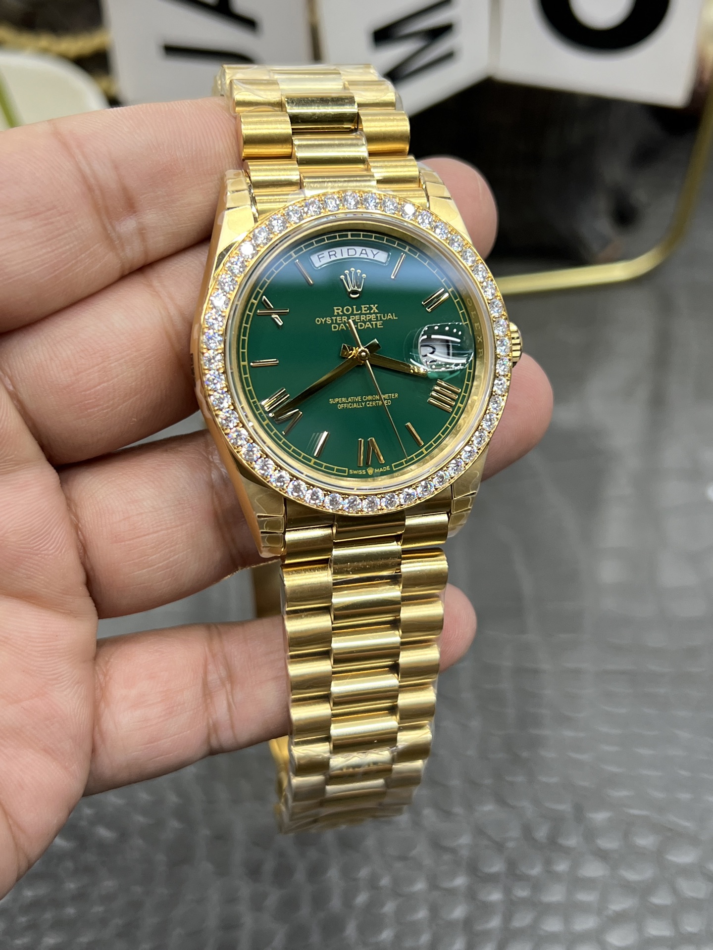 Main view of luxurious gold Rolex Day-Date replica with vibrant green dial, diamond bezel and President bracelet