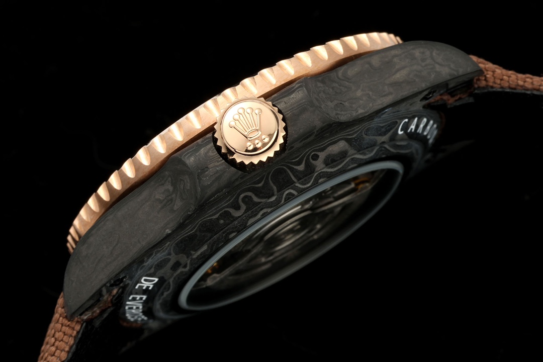 Side profile showing rose gold bezel and crown on a carbon fiber rolex replica
