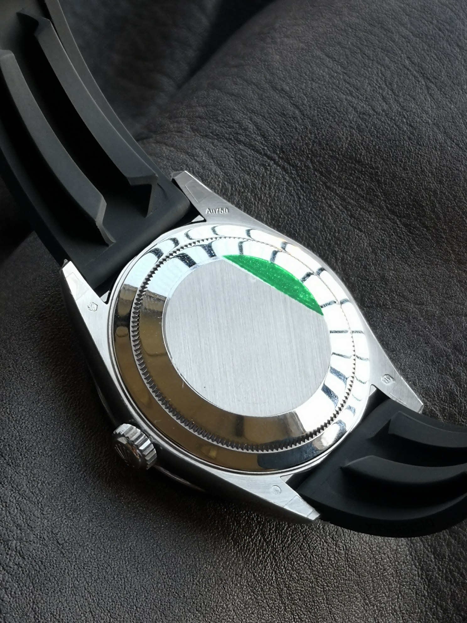 Solid case back with fluted edge and brushed finish, showing the movement's hidden architecture