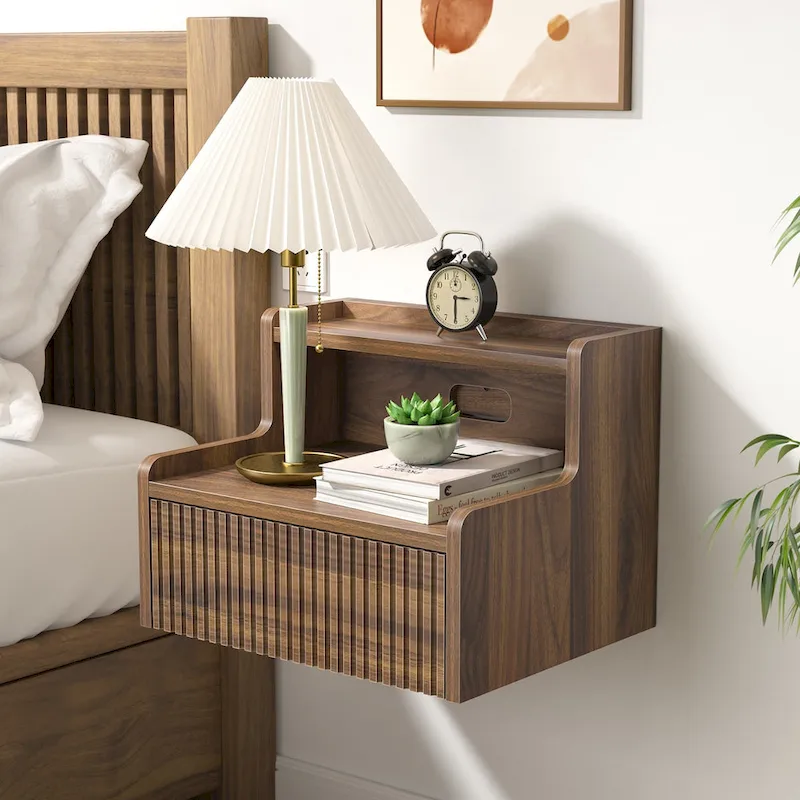Modern floating bedside table with storage drawers and open shelves.