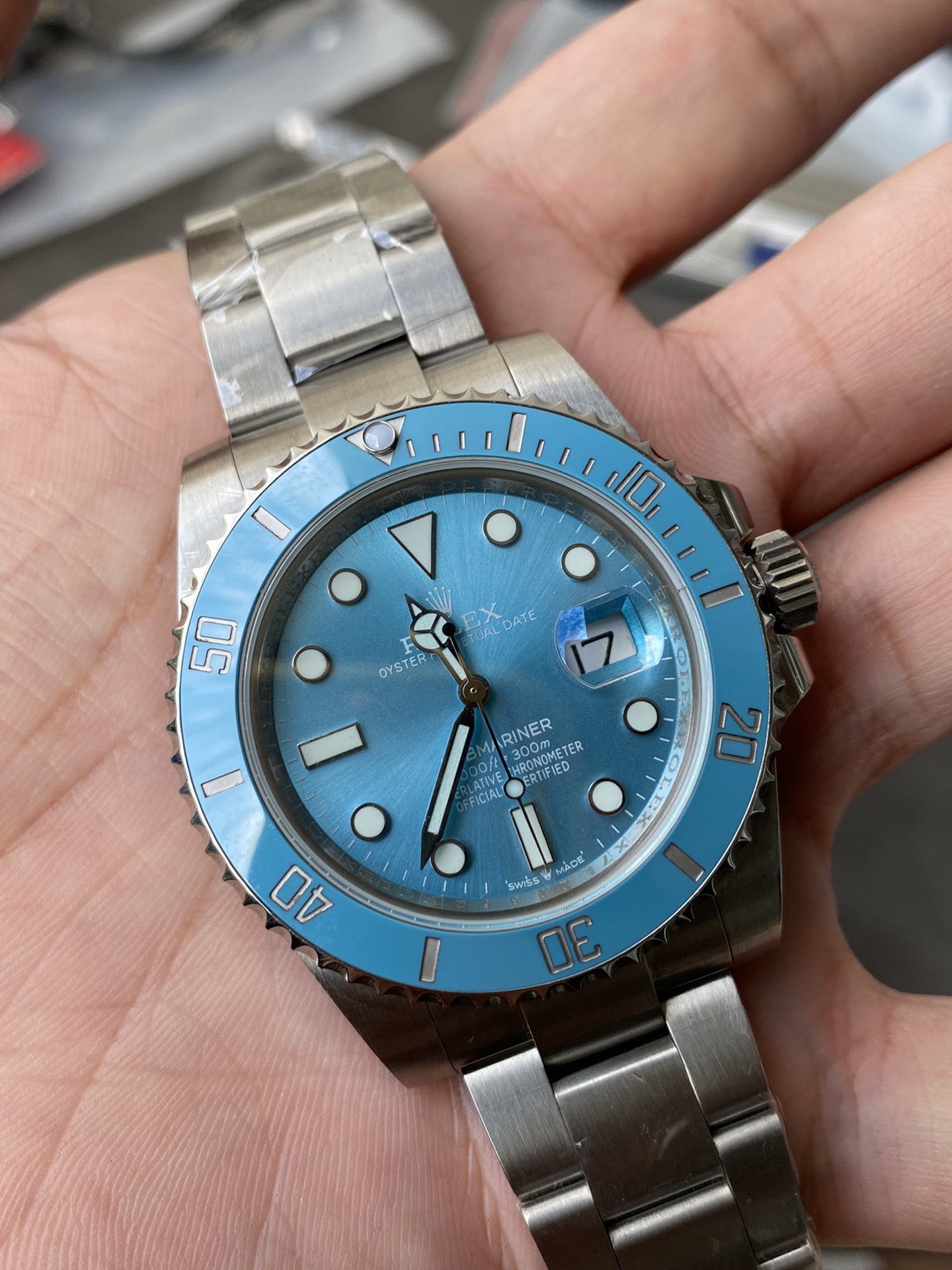 high quality rolex replica with light blue dial and ceramic bezel on wrist