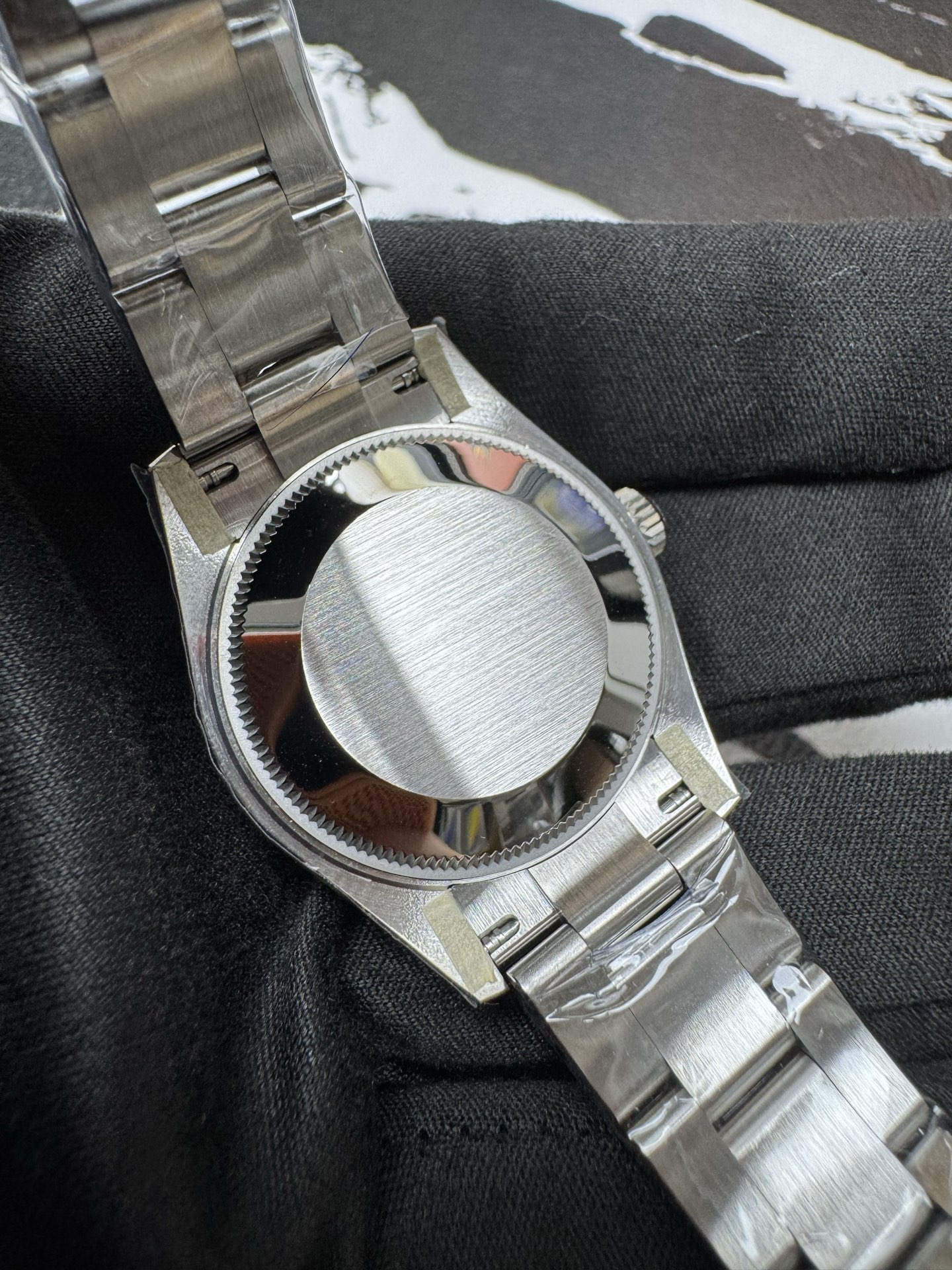 Screw-down case back with brushed finish on a high quality replica Rolex Datejust.