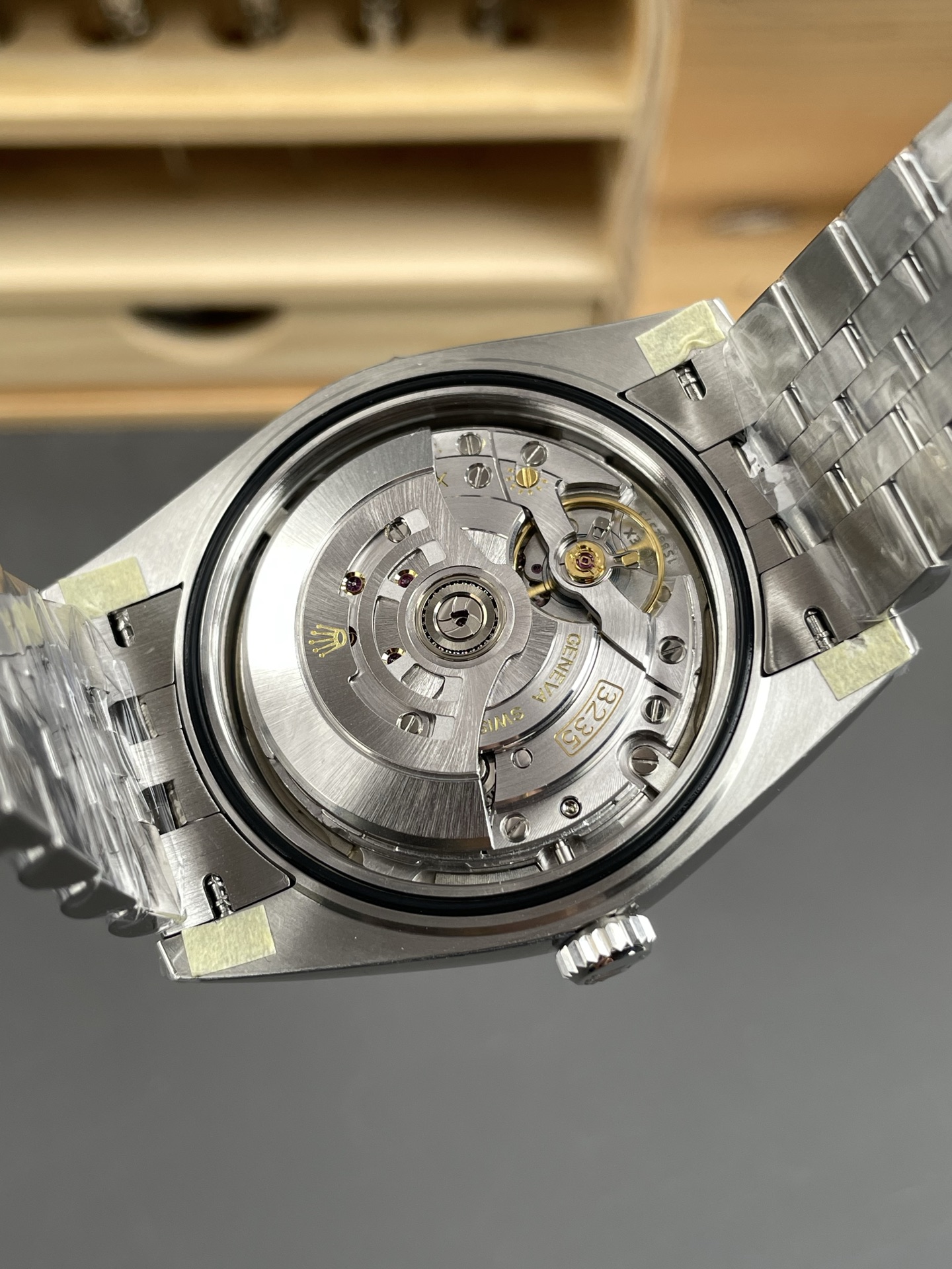 Open caseback view of 3235 clone automatic movement with decorated rotor and visible balance assembly