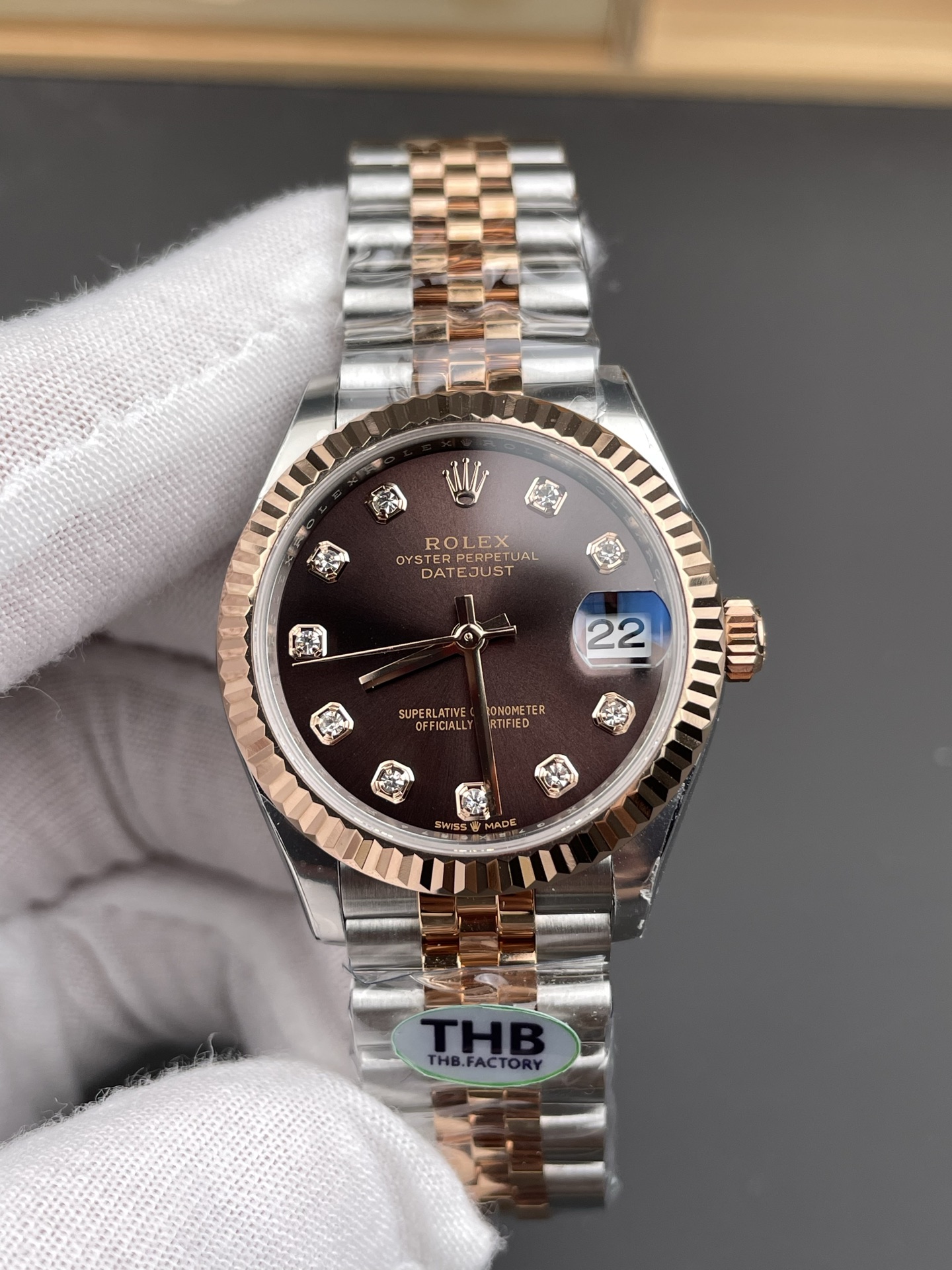 Front view of Rolex Datejust replica dial showing date window at 22, diamond hour markers and fluted rose gold bezel