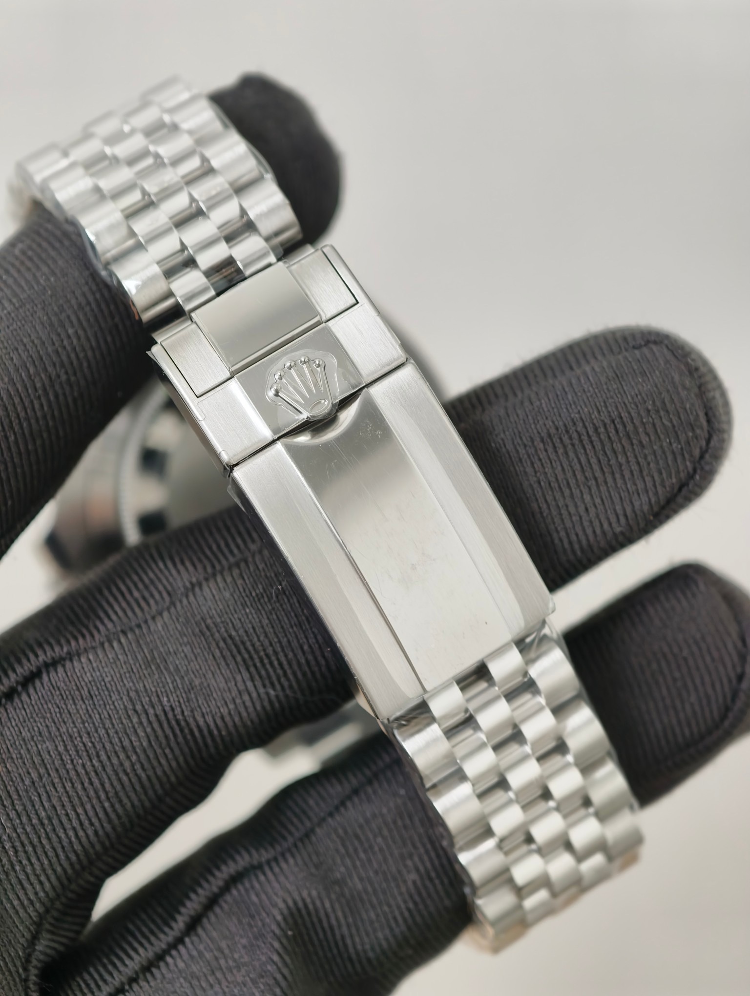 Rolex GMT-Master II replica Jubilee clasp close-up with coronet logo and brushed steel finish