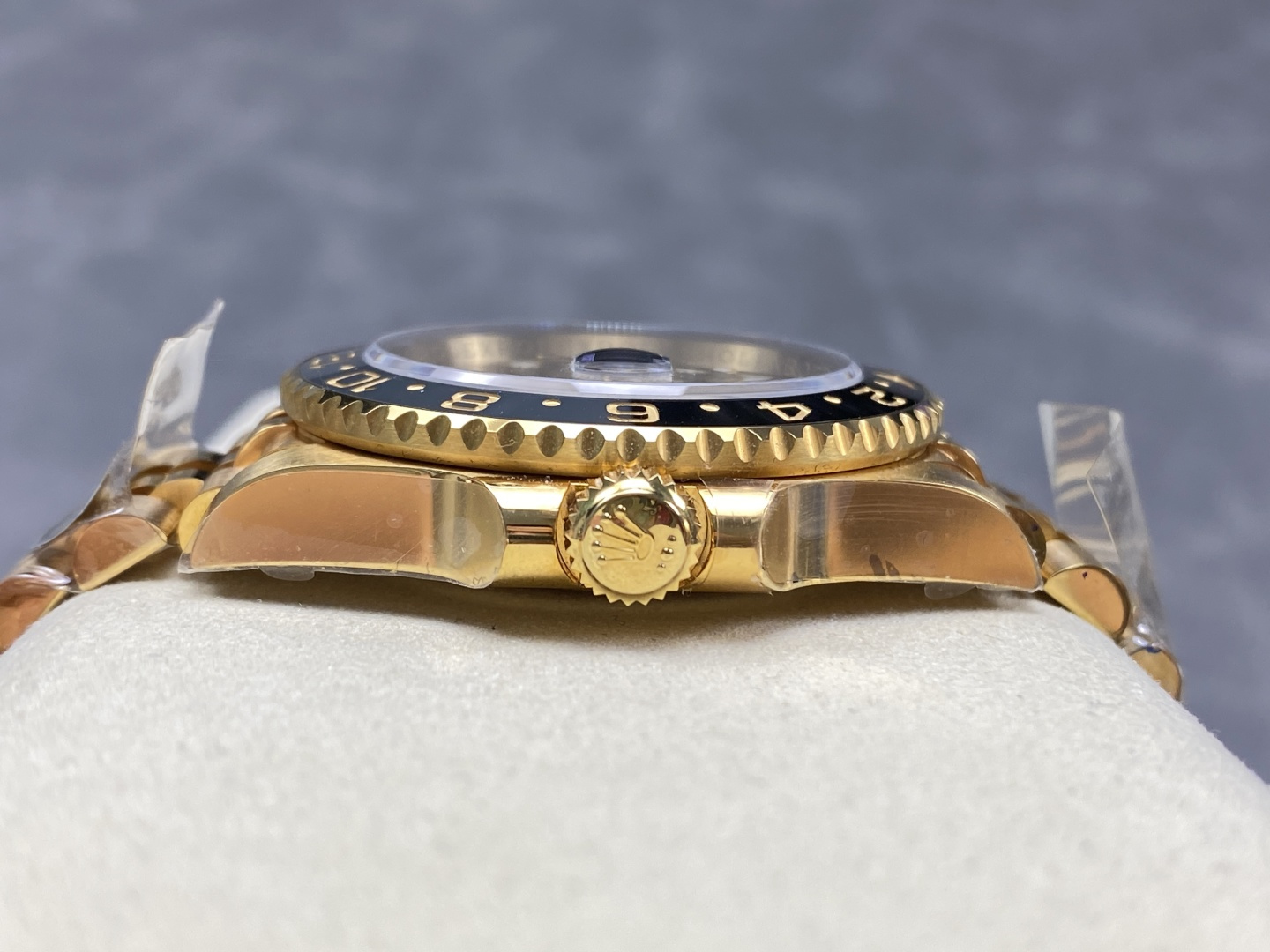 Side profile of gold Rolex GMT-Master II replica watch showing crown and bezel thickness