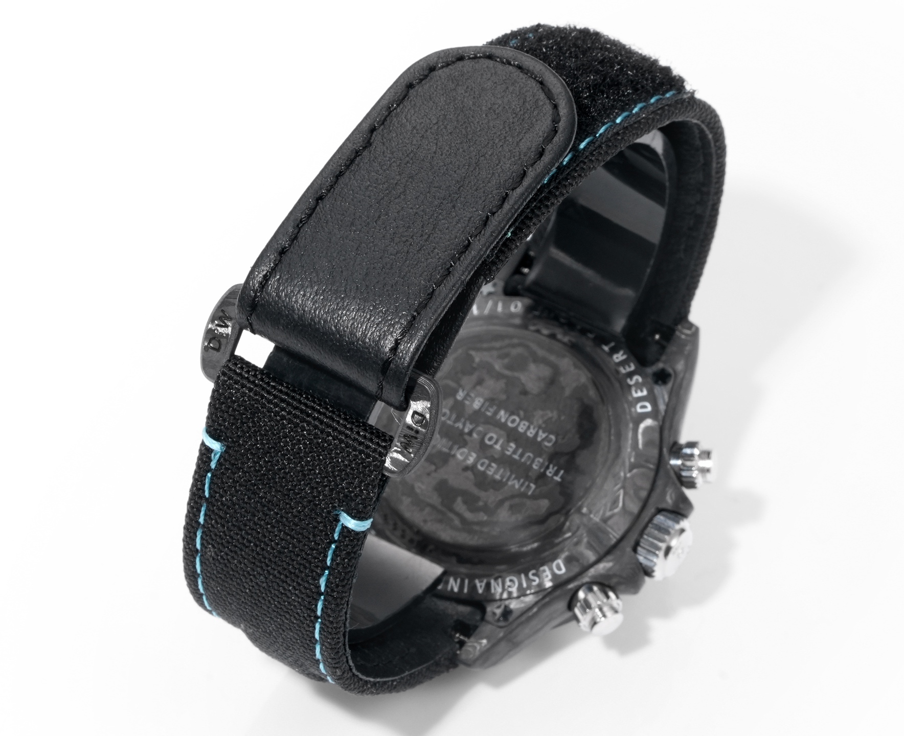 Black leather and fabric strap with light blue stitching on a replica watch