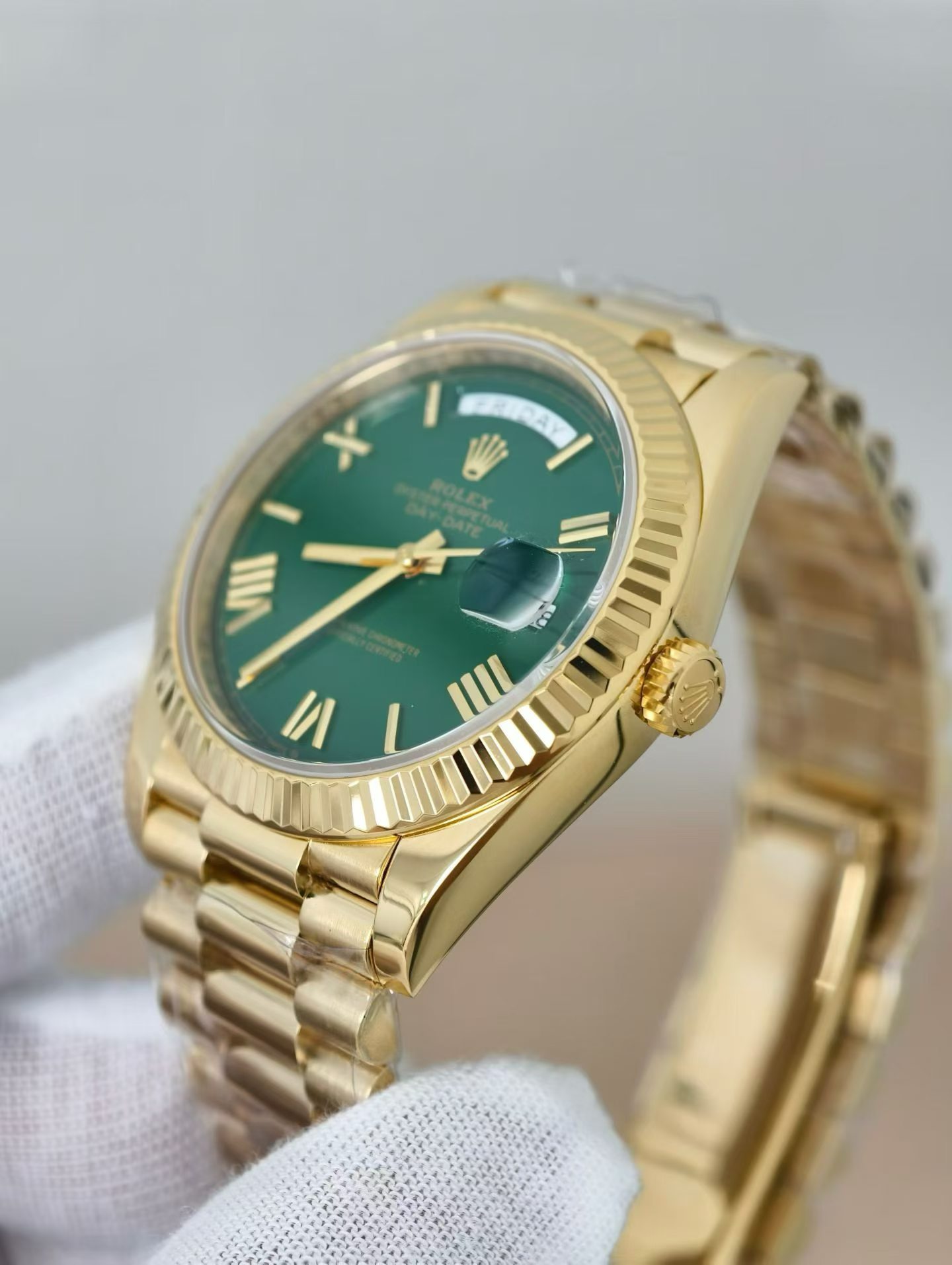Close-up macro view of the gold Rolex Day-Date replica dial with Roman numerals and Cyclops lens over date
