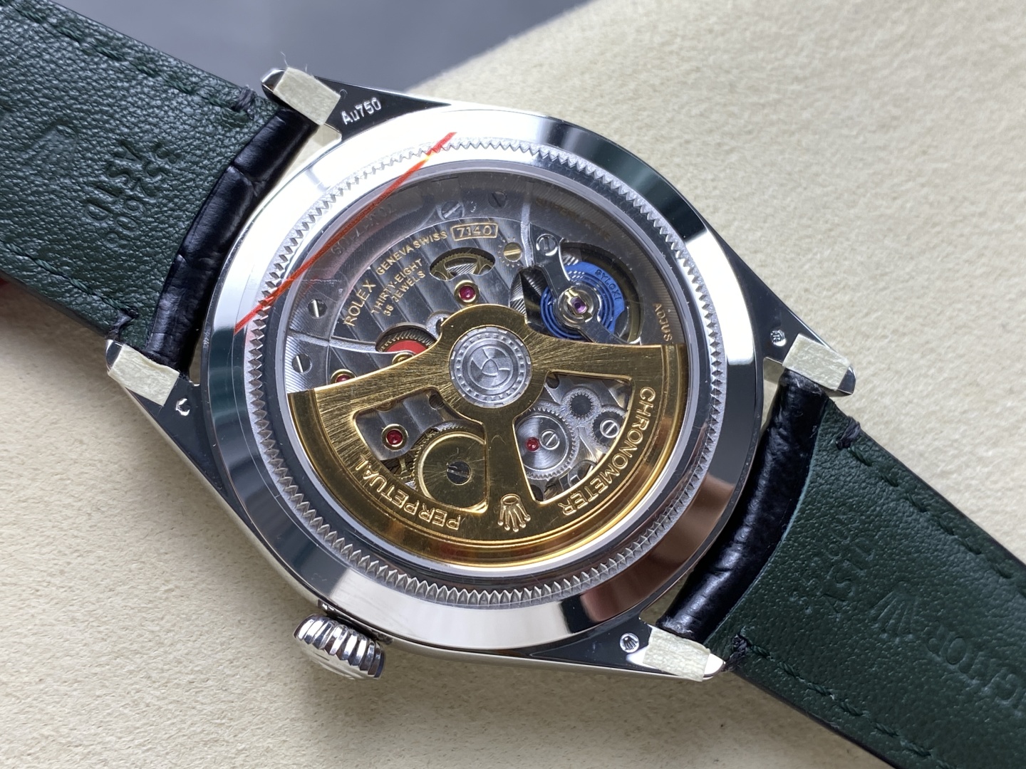 Transparent caseback of Rolex 1908 replica revealing gold rotor, engravings, and 7140 clone movement details