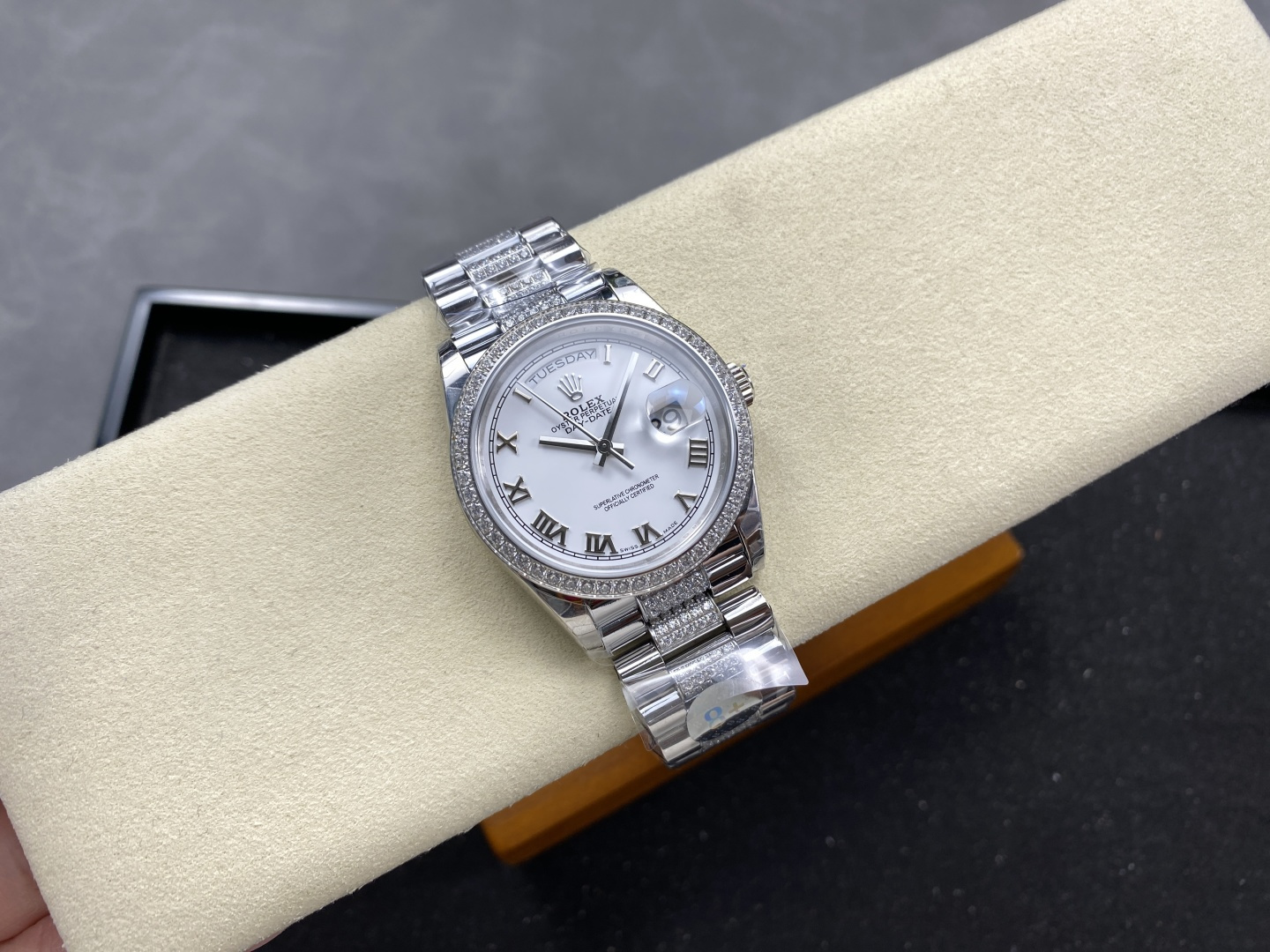 Rolex Day-Date 40mm silver dial diamond-set bezel and bracelet replica watch on cream cushion