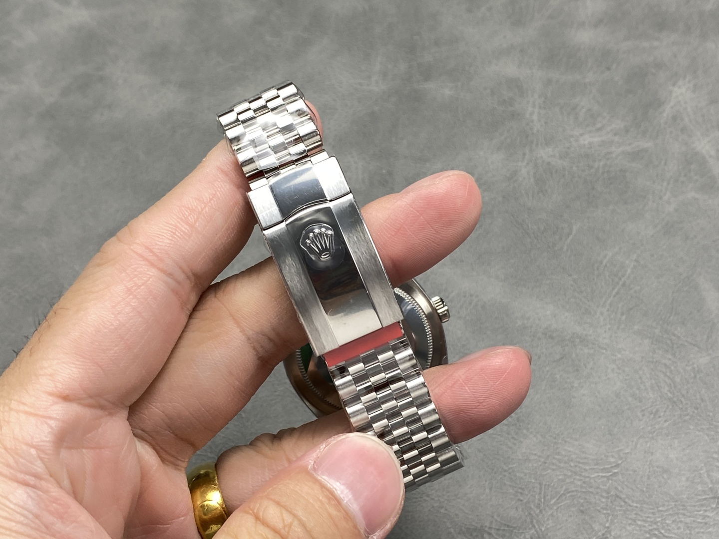 Fold-over clasp of a Clean Factory Datejust 41 showing the embossed crown logo
