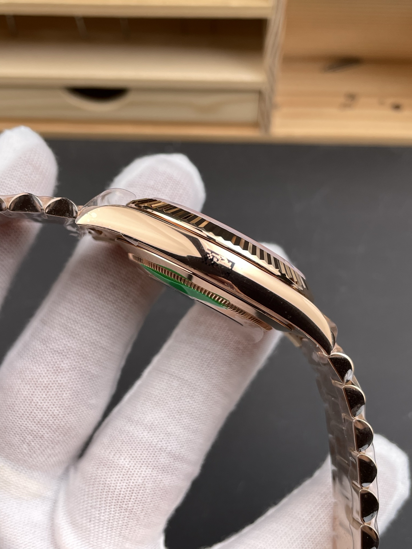 Rose gold Day-Date replica watch side profile showing polished case and fluted bezel