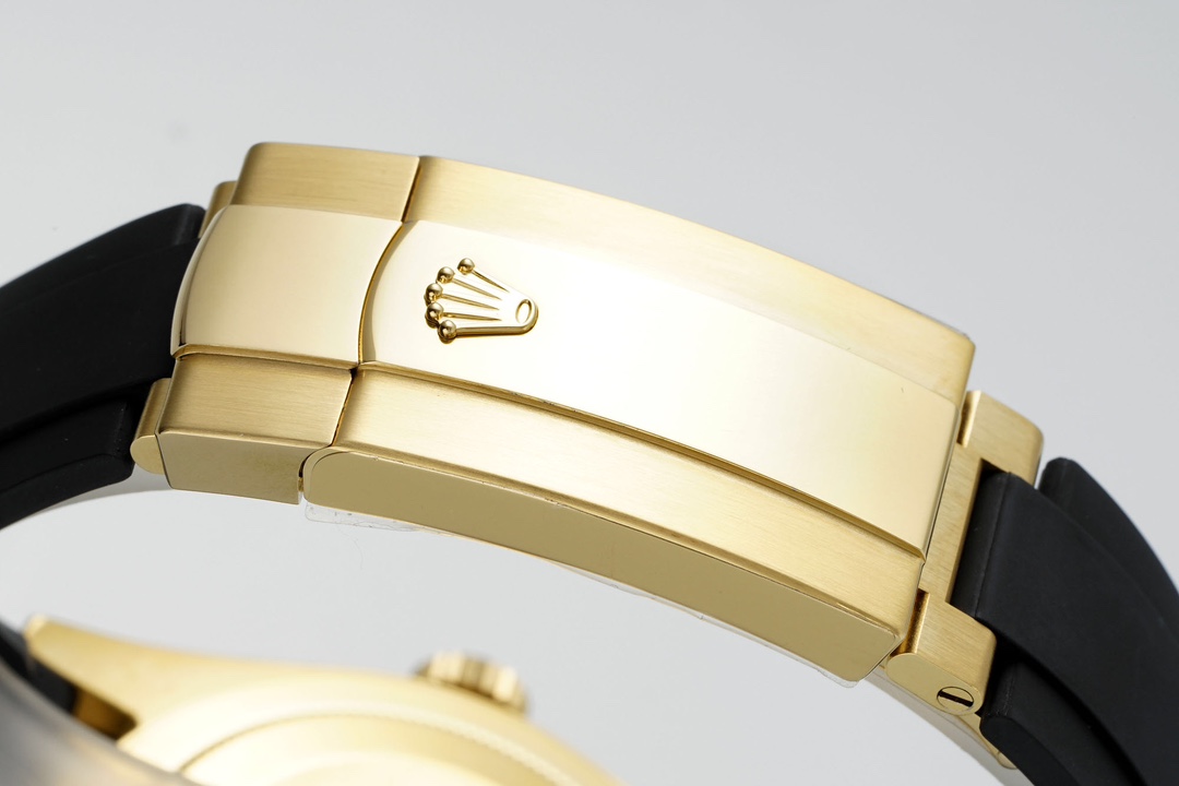 Close-up of the polished gold Oysterflex clasp with the Rolex crown logo
