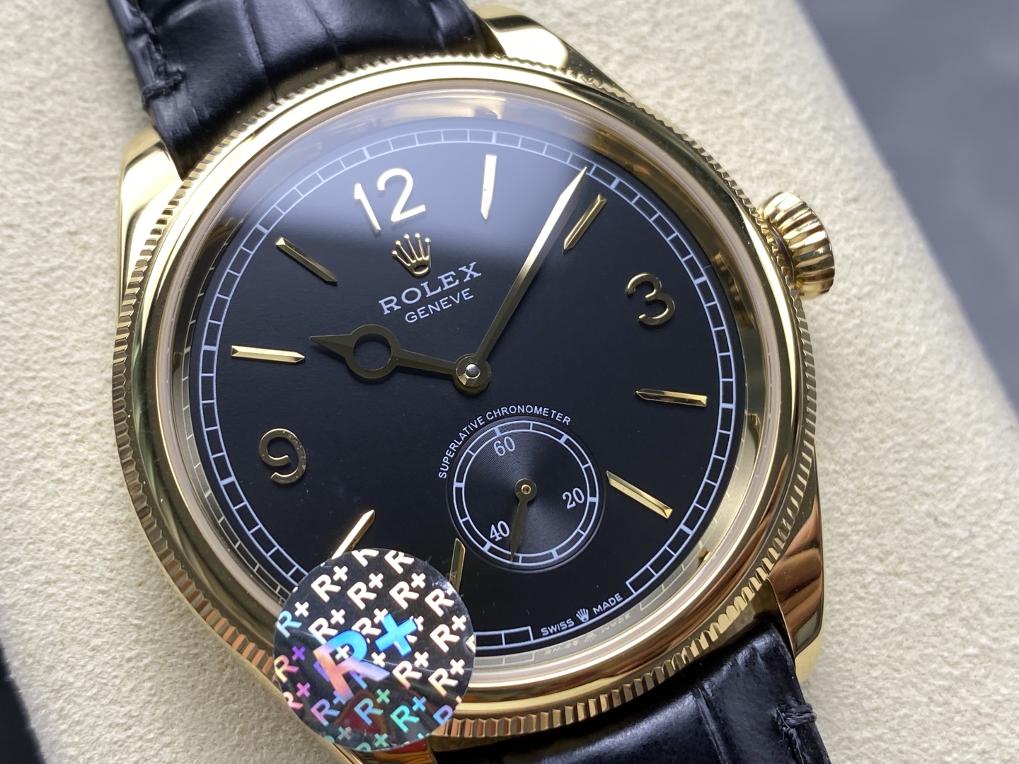 Close-up dial view of a black and gold Rolex replica watch with small seconds subdial