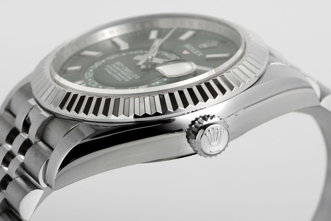 Close-up high-resolution photo of Rolex deployant clasp with engraved crown logo, polished and brushed stainless steel construction, and Jubilee bracelet honeycomb links