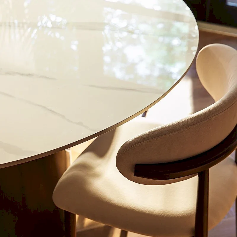 Modern Round Dining Table – White Sintered Stone Top & Bronze Carbon Pedestal