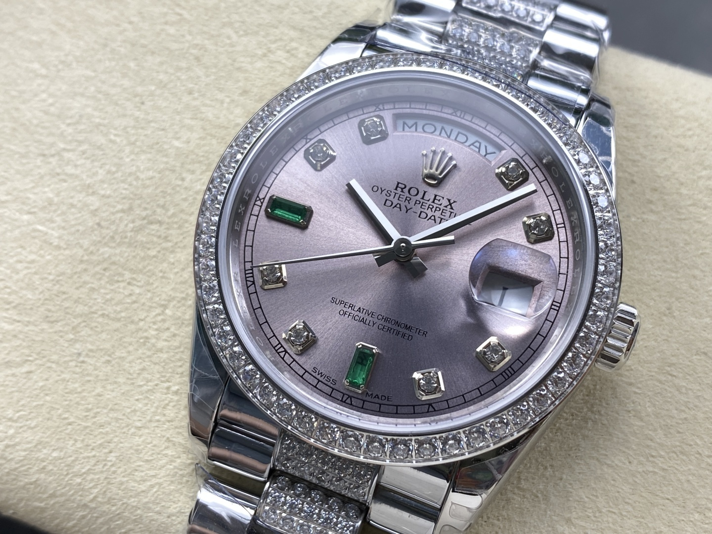 close-up of the dial showing rolex crown and emerald markers