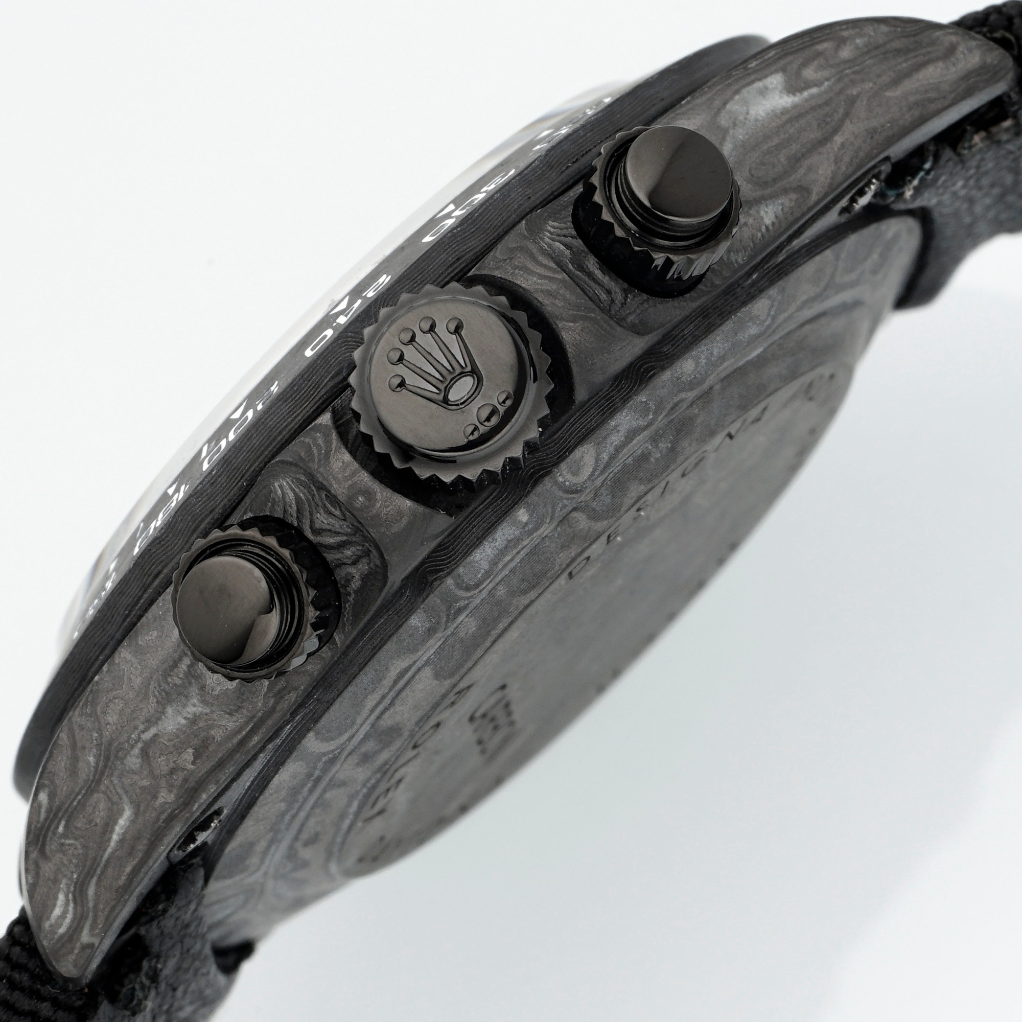 Rolex Daytona carbon case side view with crown and pushers