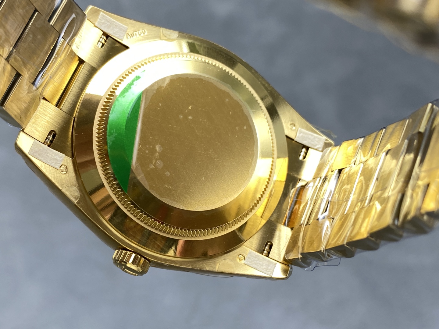 Caseback and bracelet underside of gold Rolex Day-Date replica showing solid back and end link finishing