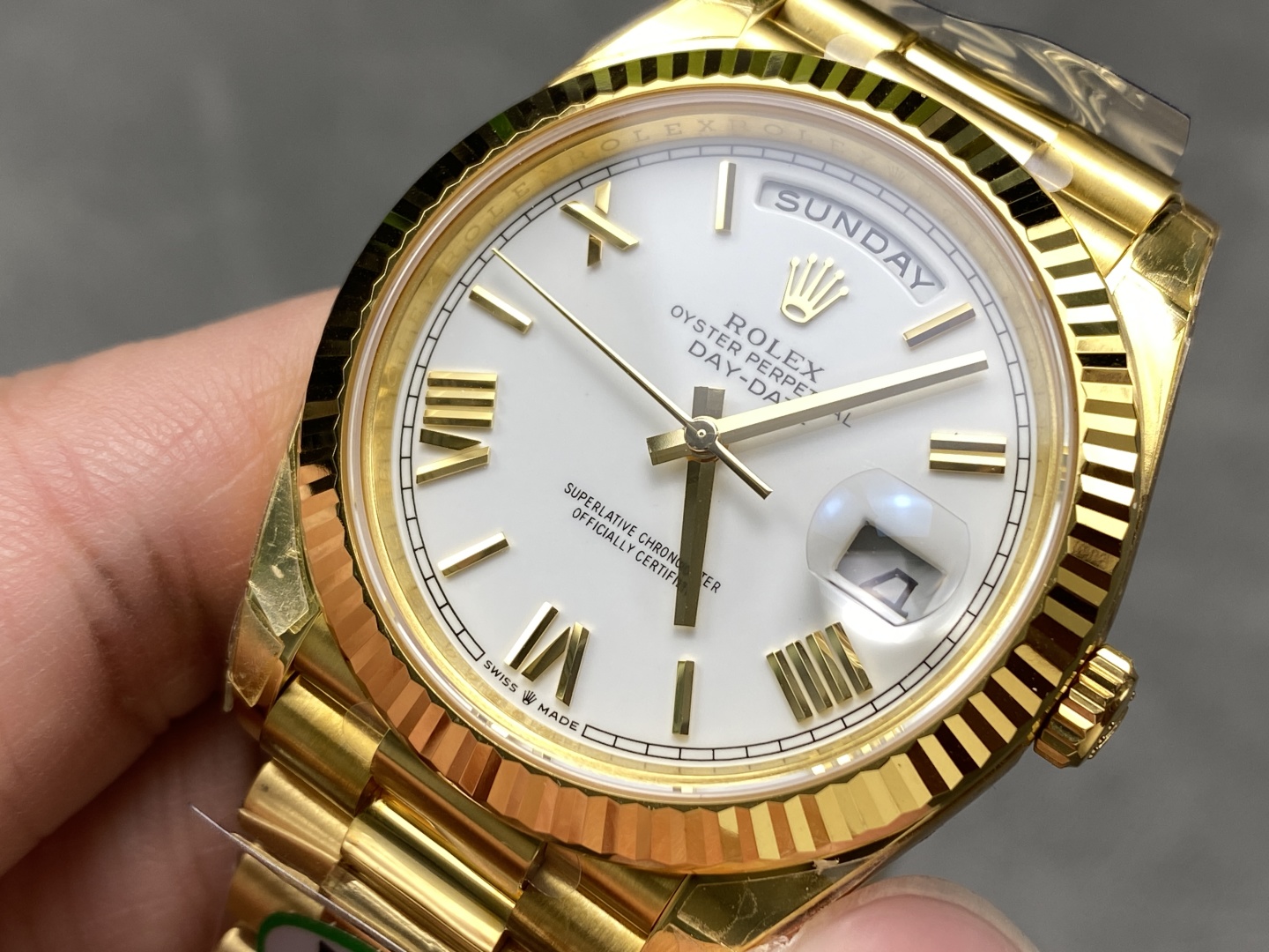Close-up macro view of Rolex Day-Date replica white dial fluted bezel cyclops window and gold markers