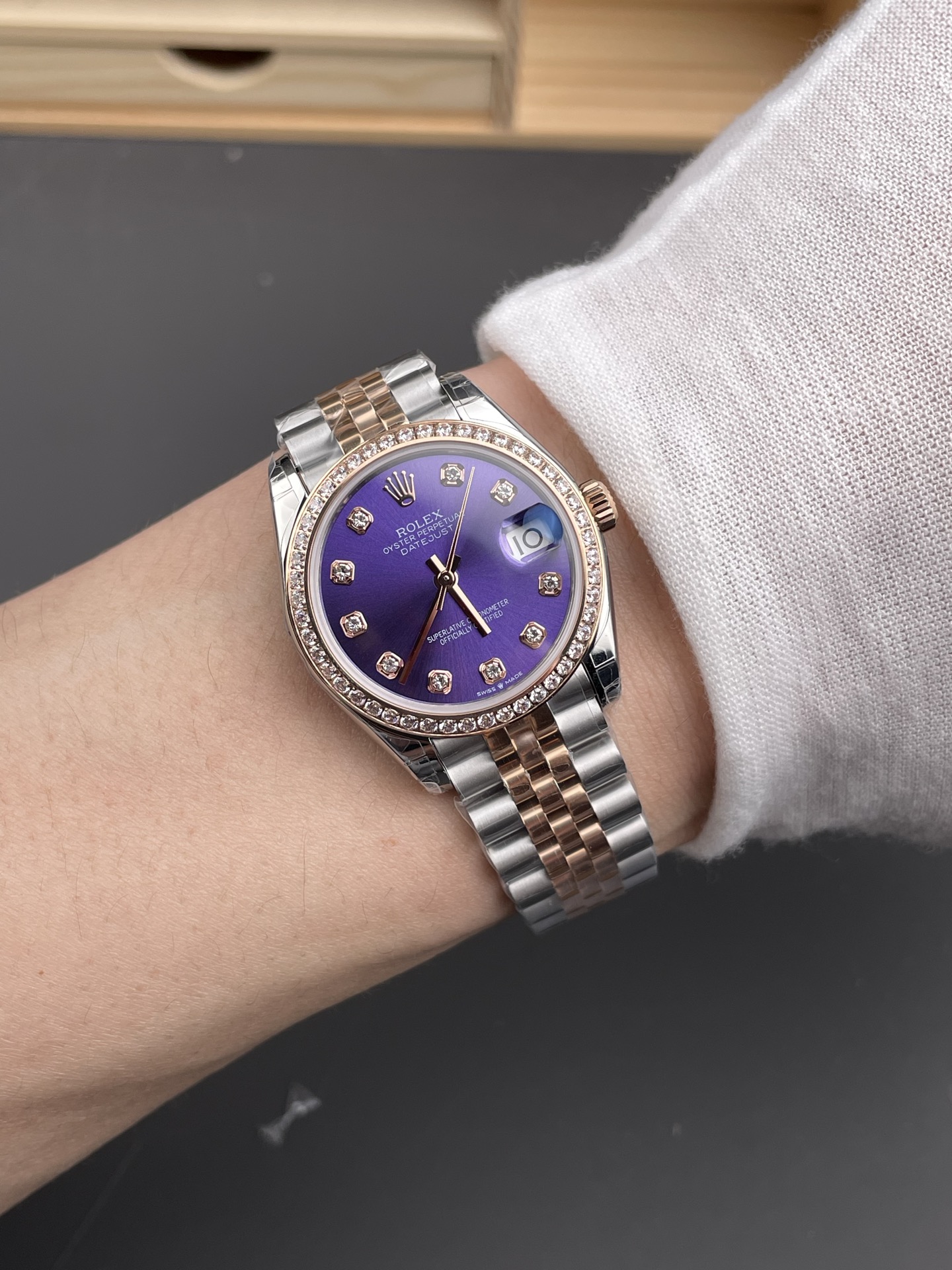 Two tone purple dial Rolex Datejust replica watch worn on the wrist with diamond bezel