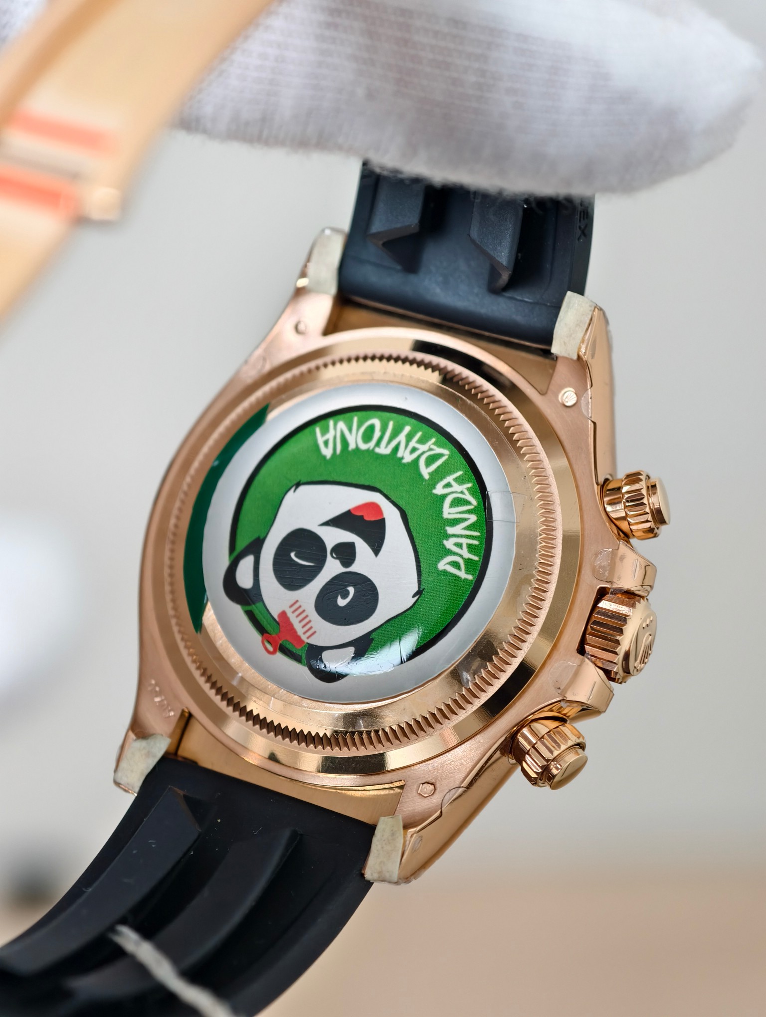 Rose gold caseback of luxury replica watch featuring custom panda engraving