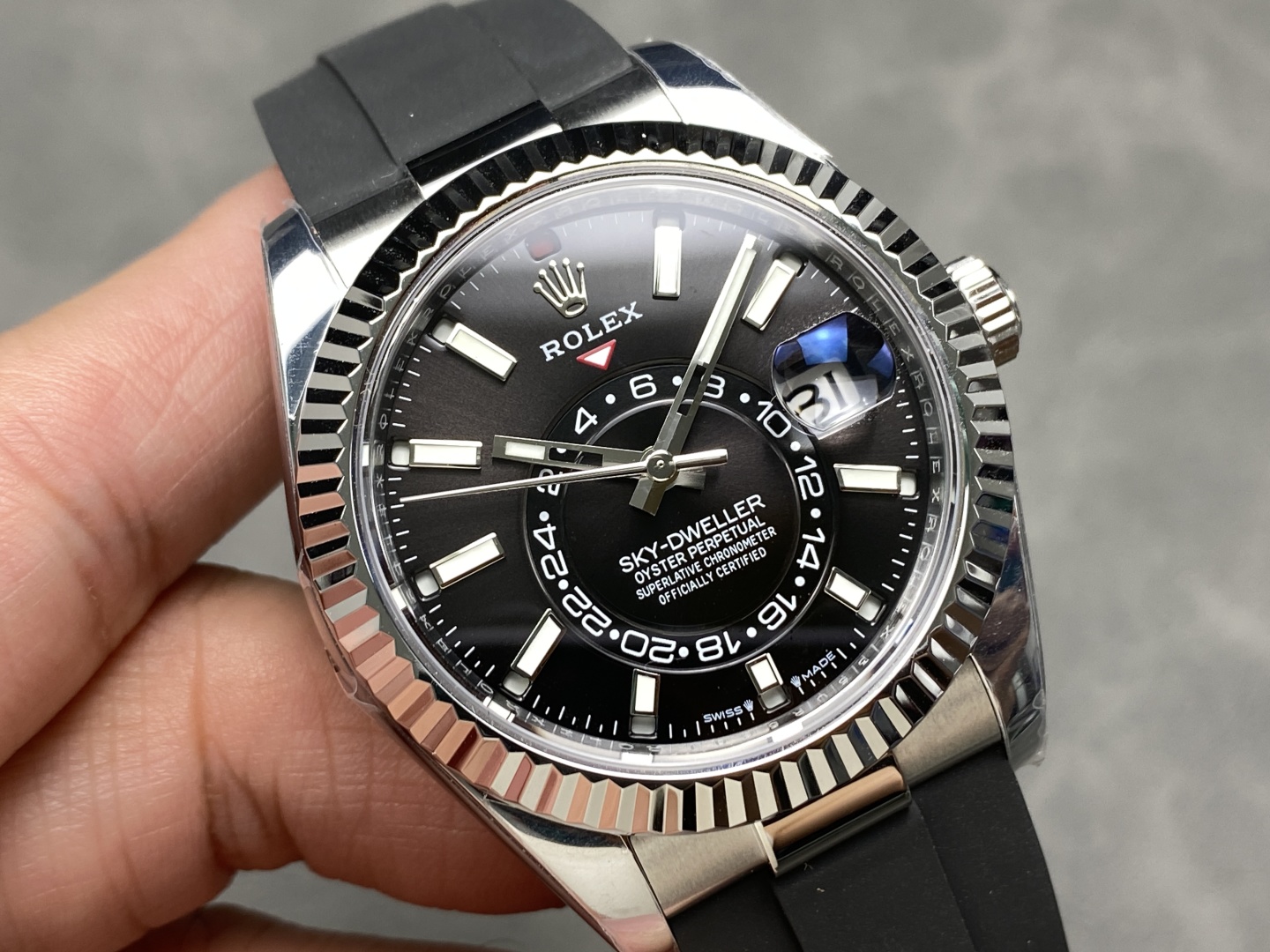 Close-up black dial Rolex Sky-Dweller replica with fluted bezel and Oysterflex strap