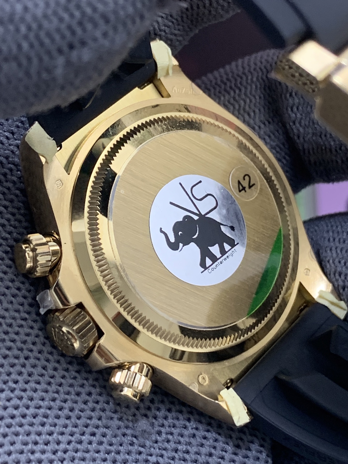 Caseback view of gold-tone rolex replica showing solid back and engraved edge