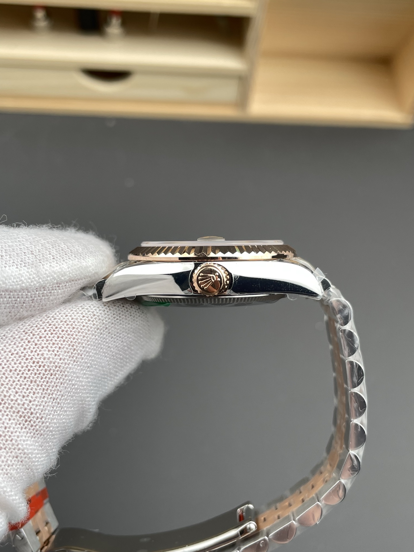 Side profile of Rolex replica Datejust showing fluted bezel and crown detail