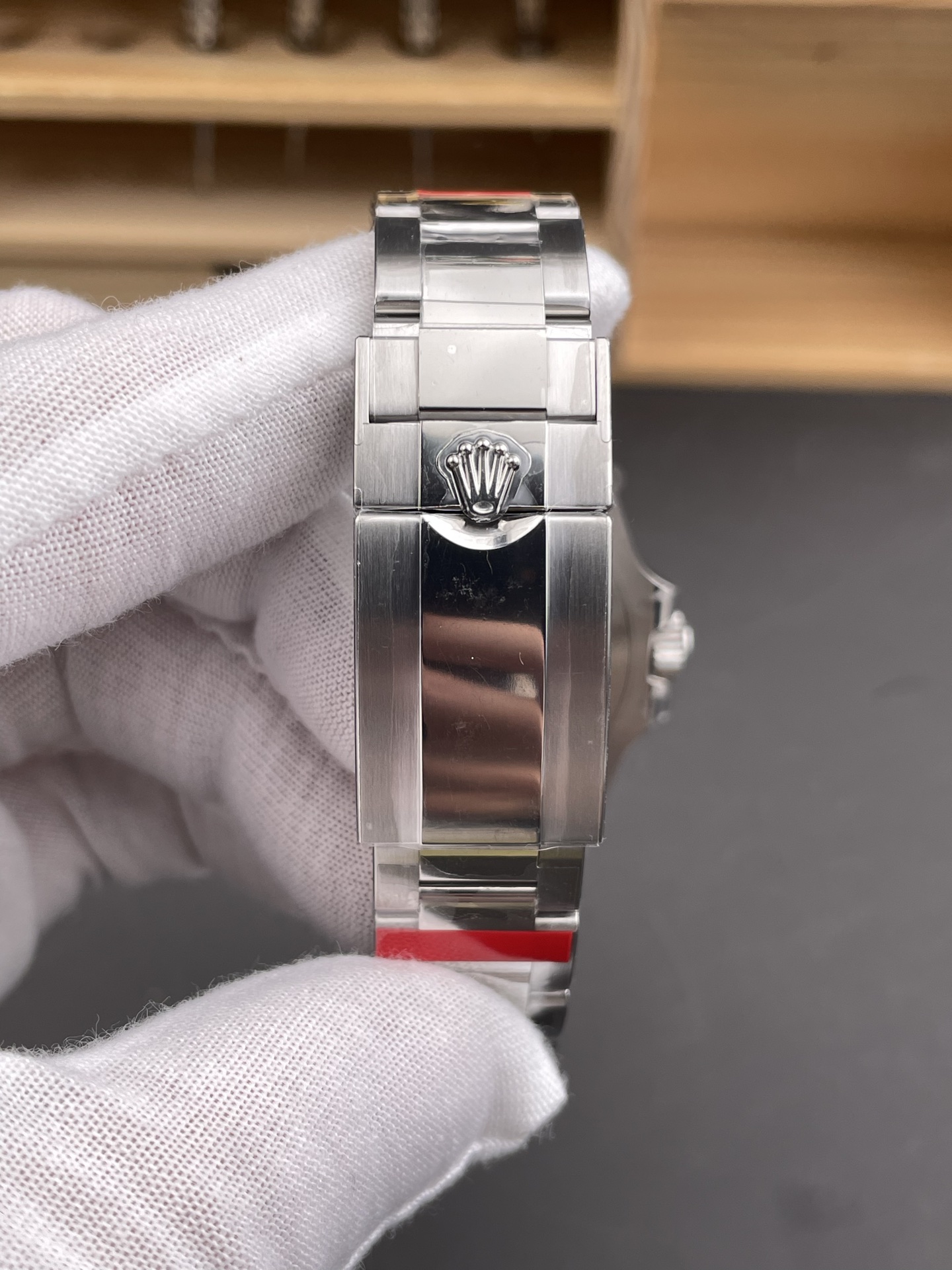 Rolex GMT-Master II replica Oyster clasp close-up with coronet logo and brushed steel finish