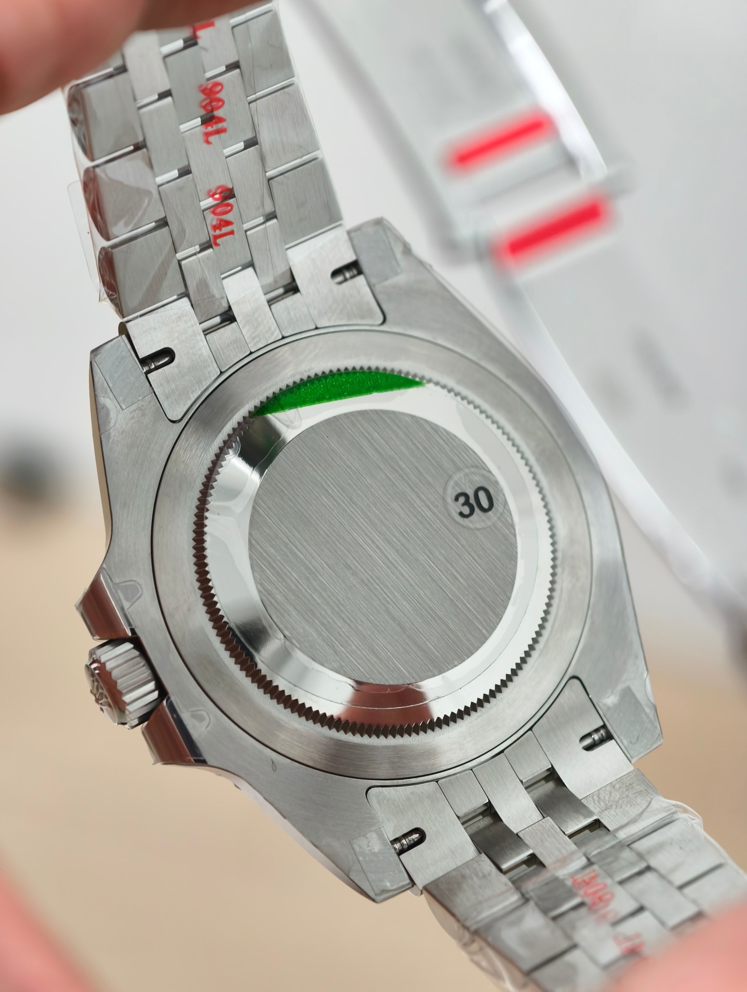 Rolex GMT-Master II replica caseback detail with brushed steel finish and solid back construction