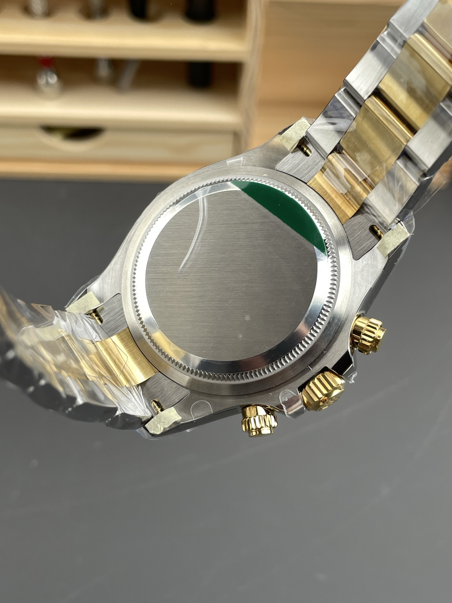Case back view of the luxury chronograph replica with screw-down bezel and protective film