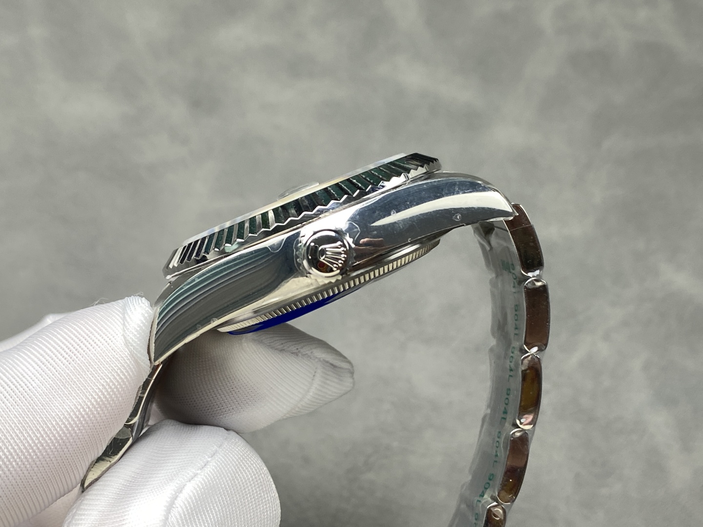 Side profile of Rolex Sky-Dweller replica showing case thickness crown and fluted bezel