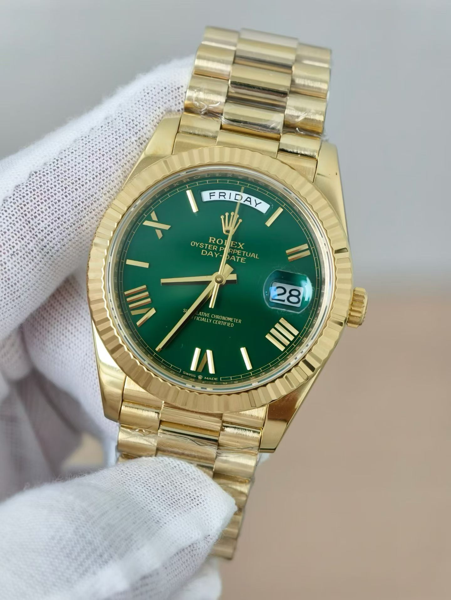 Back view of gold Rolex replica watch case showing screw-down bezel, crown, and engravings on lugs