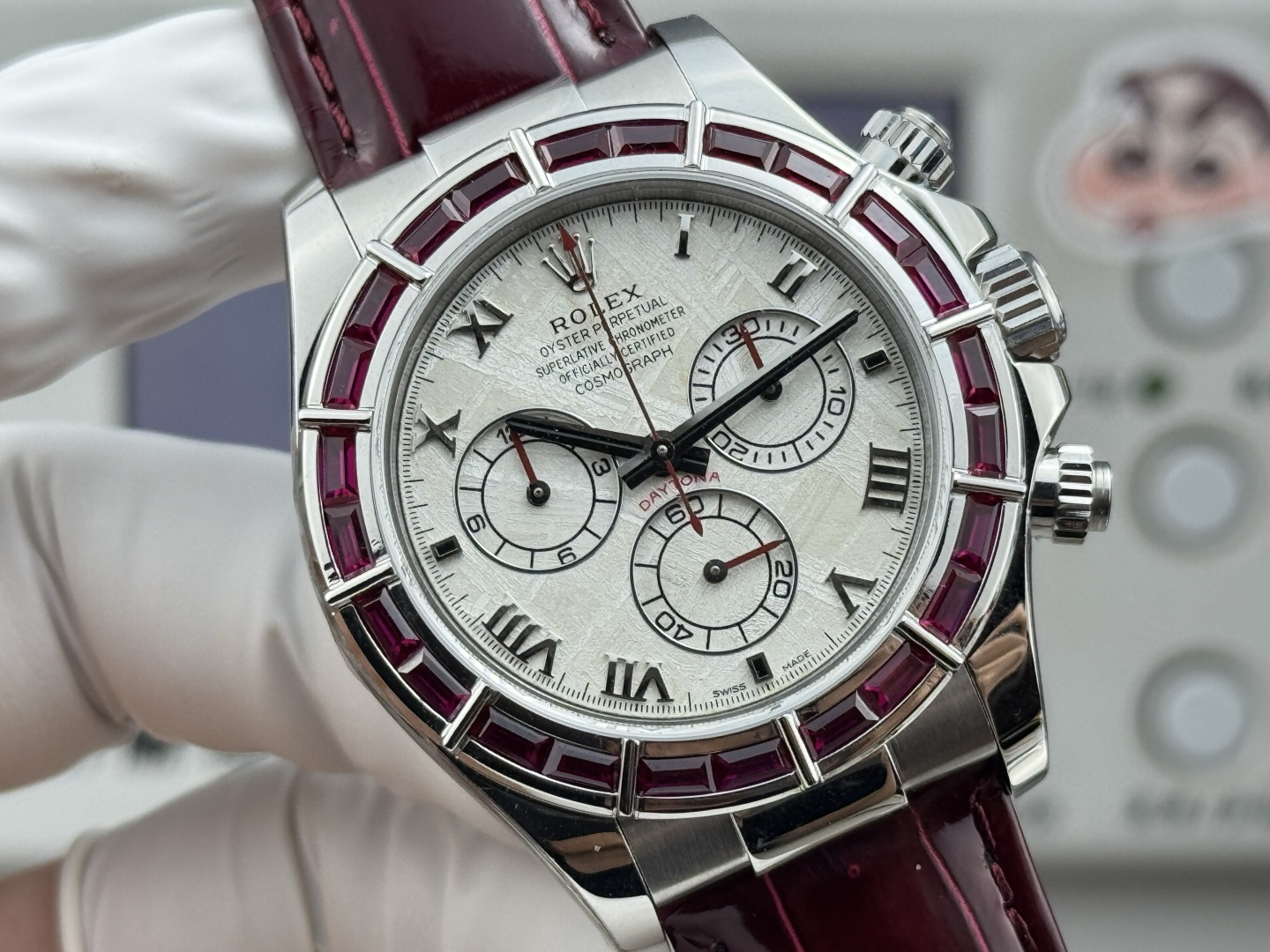 Rolex Daytona replica front view with ruby bezel and burgundy leather strap