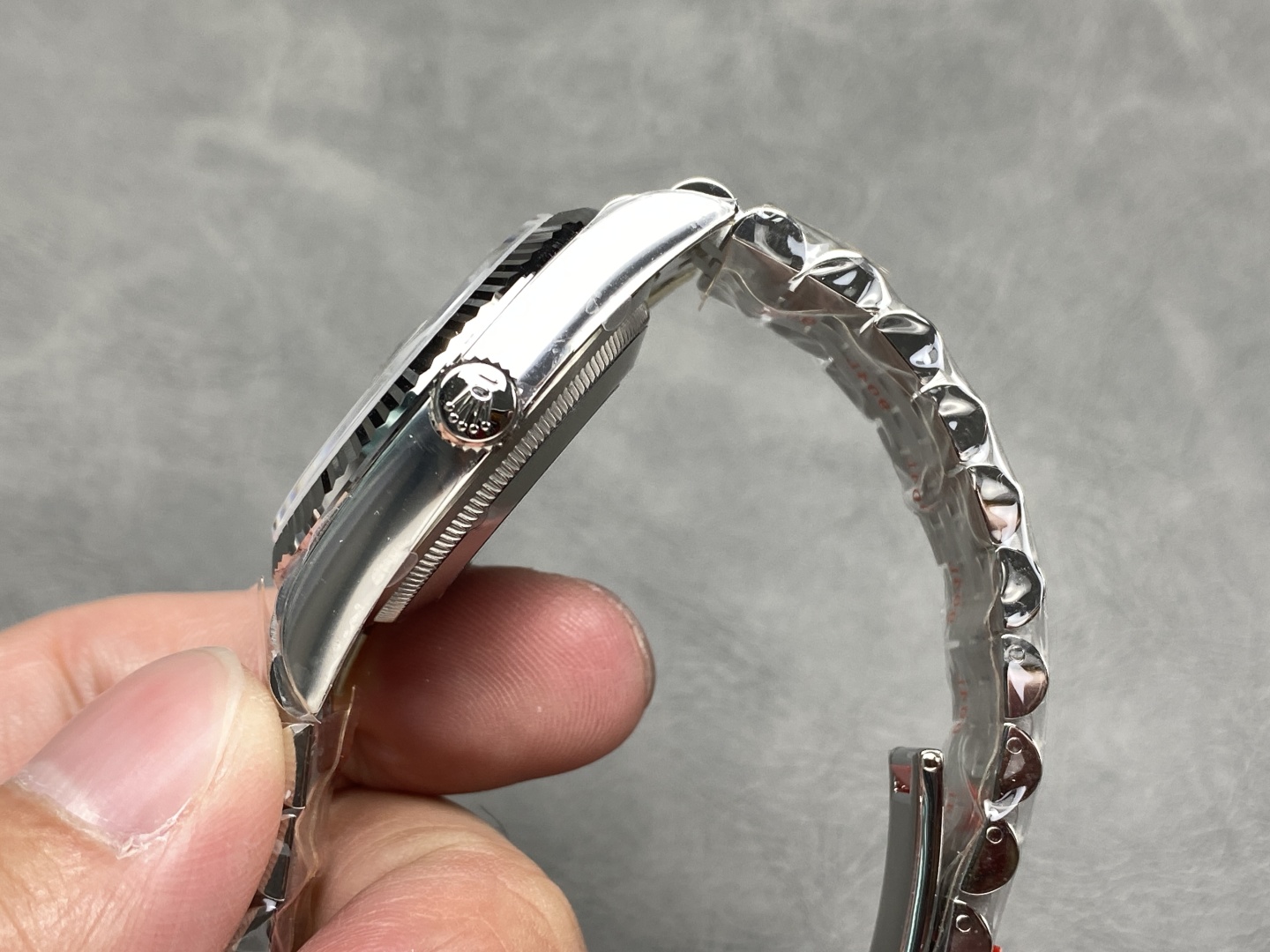 Side profile of a Clean Factory Datejust 41 showing the crown and Jubilee bracelet