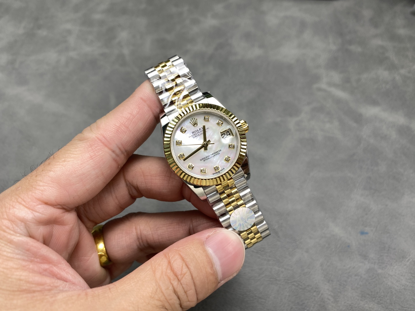 Replica rolex Datejust 36mm on hand showing two-tone Jubilee bracelet and fluted bezel