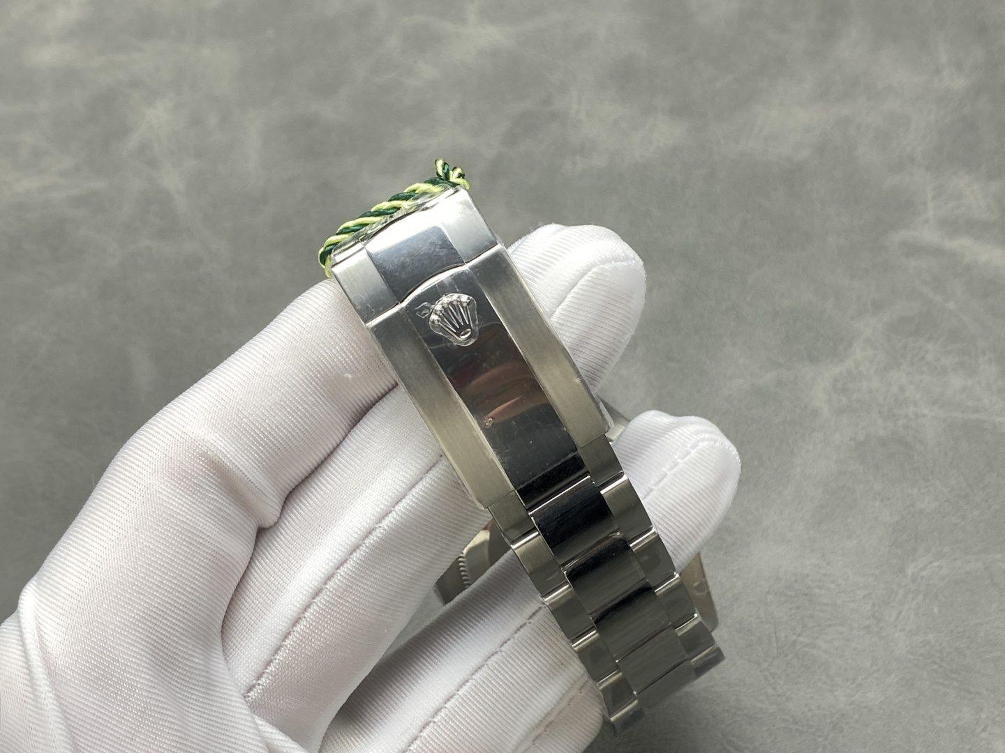 Rolex replica Oyster bracelet clasp close-up with polished center link and crown logo