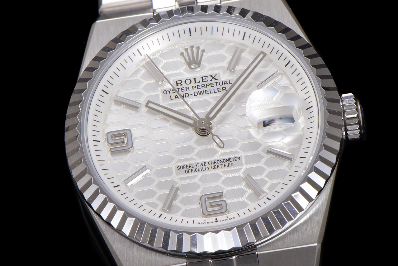 Macro dial view of faux Rolex Land-Dweller with white honeycomb dial and cyclops date lens