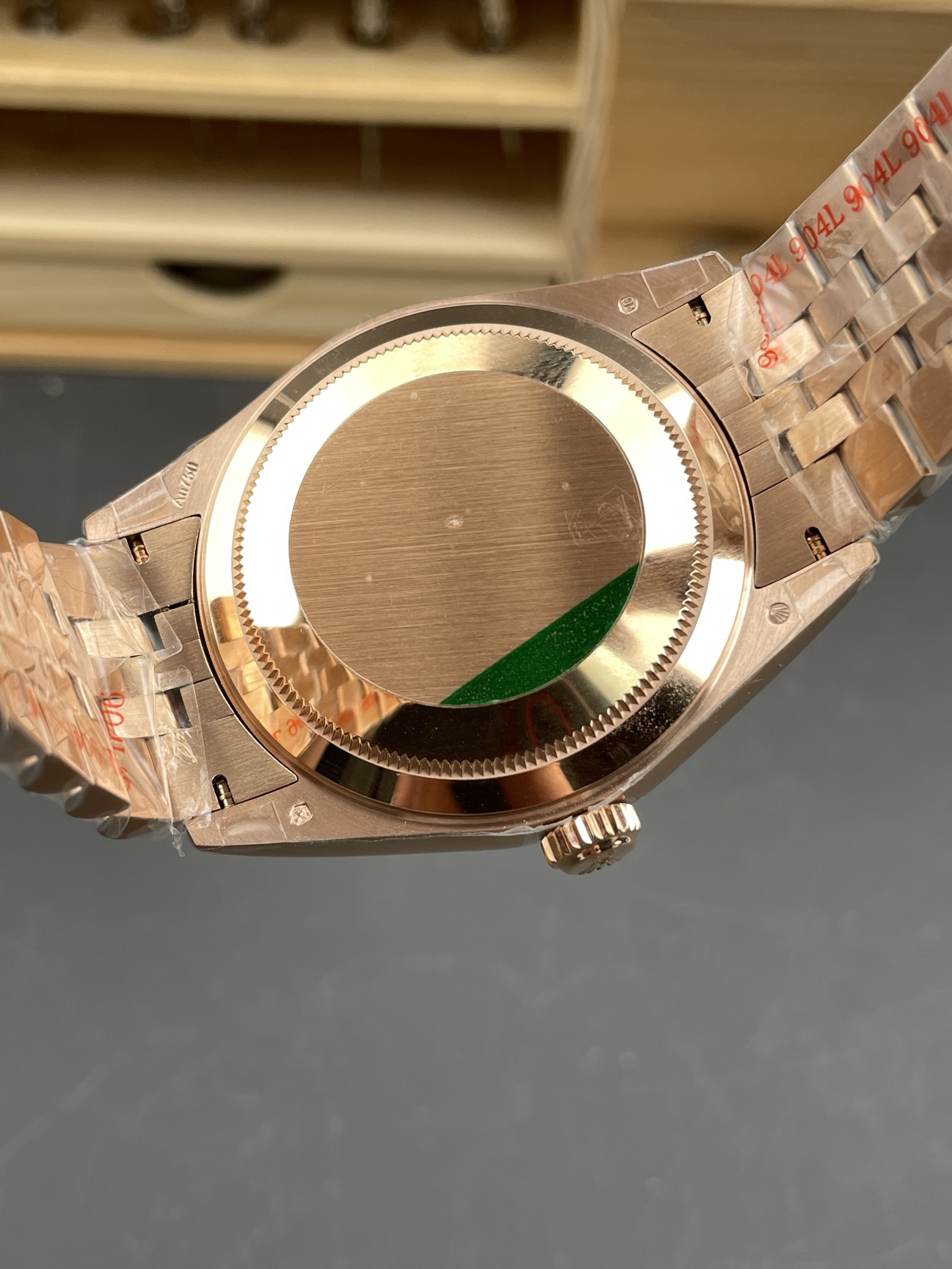 Rose gold Rolex replica caseback with protective film and bracelet detail
