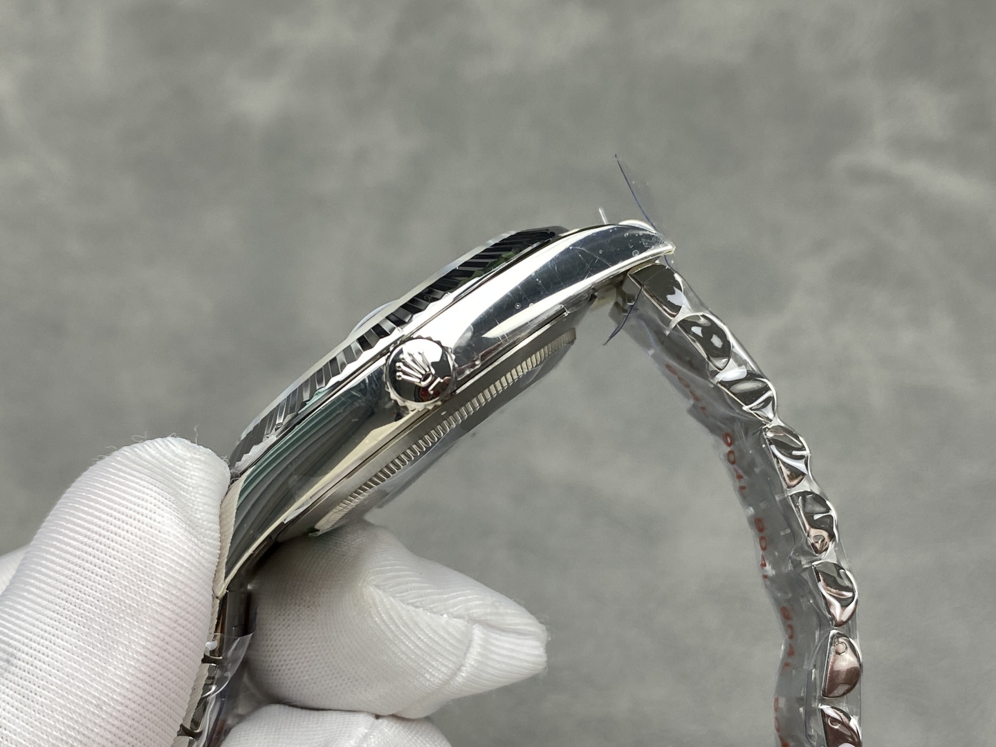 Side profile of the watch case and crown with protective film