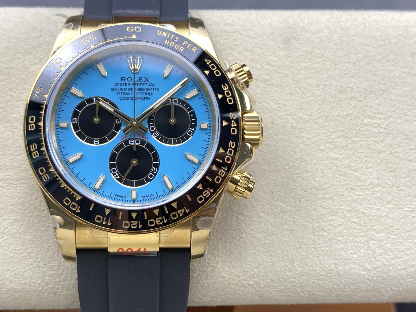 Close-up of luxury replica chronograph with vibrant blue dial, gold markers and authentic 4131 movement details