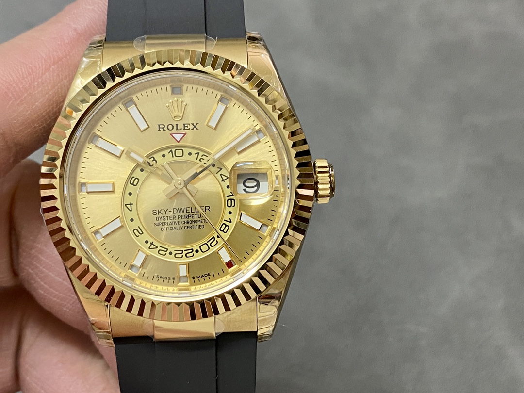 Gold Rolex Sky-Dweller replica with black rubber strap and fluted bezel