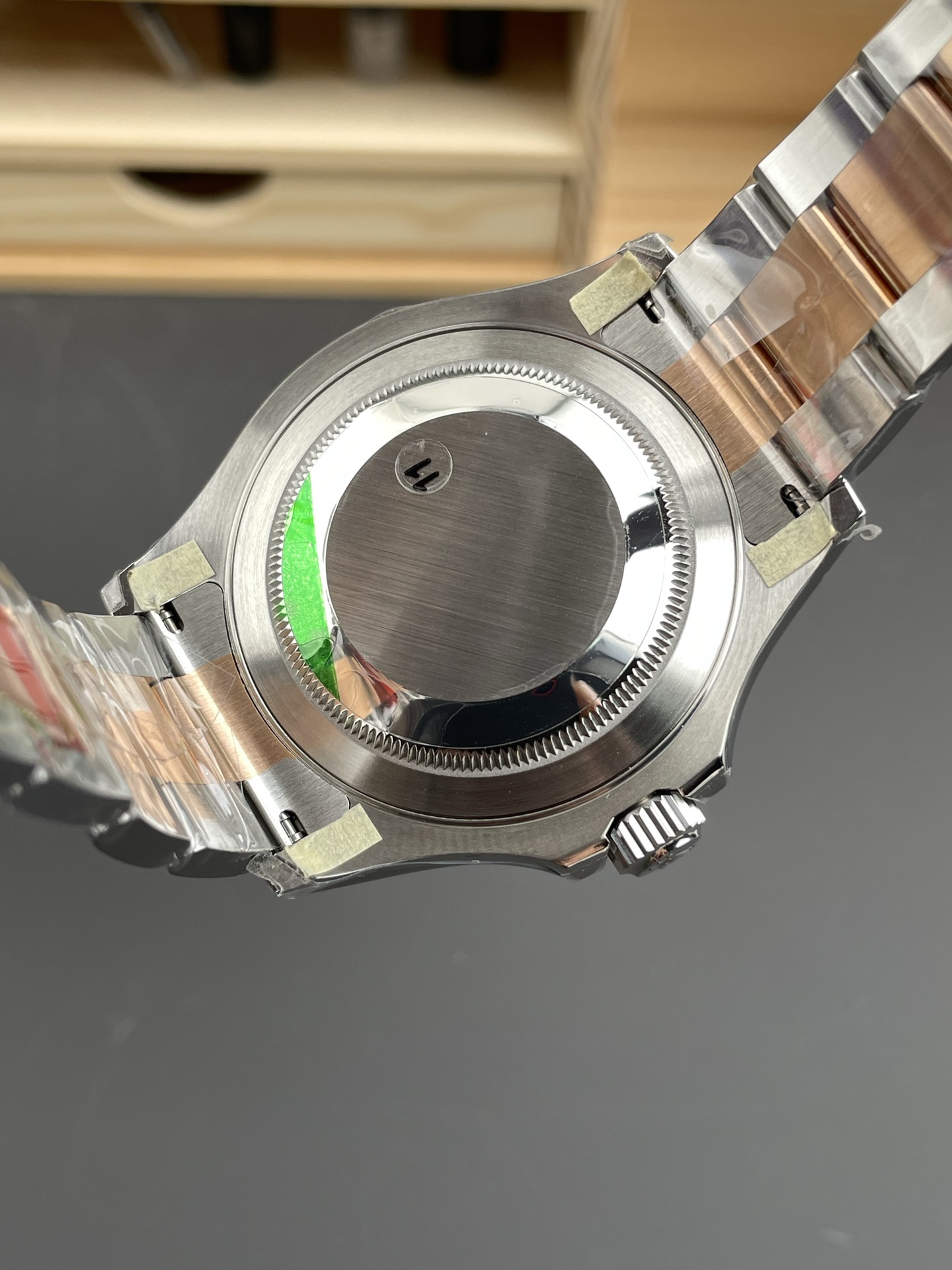 Caseback view of two-tone Rolex Yacht-Master replica showing bracelet links and protective stickers